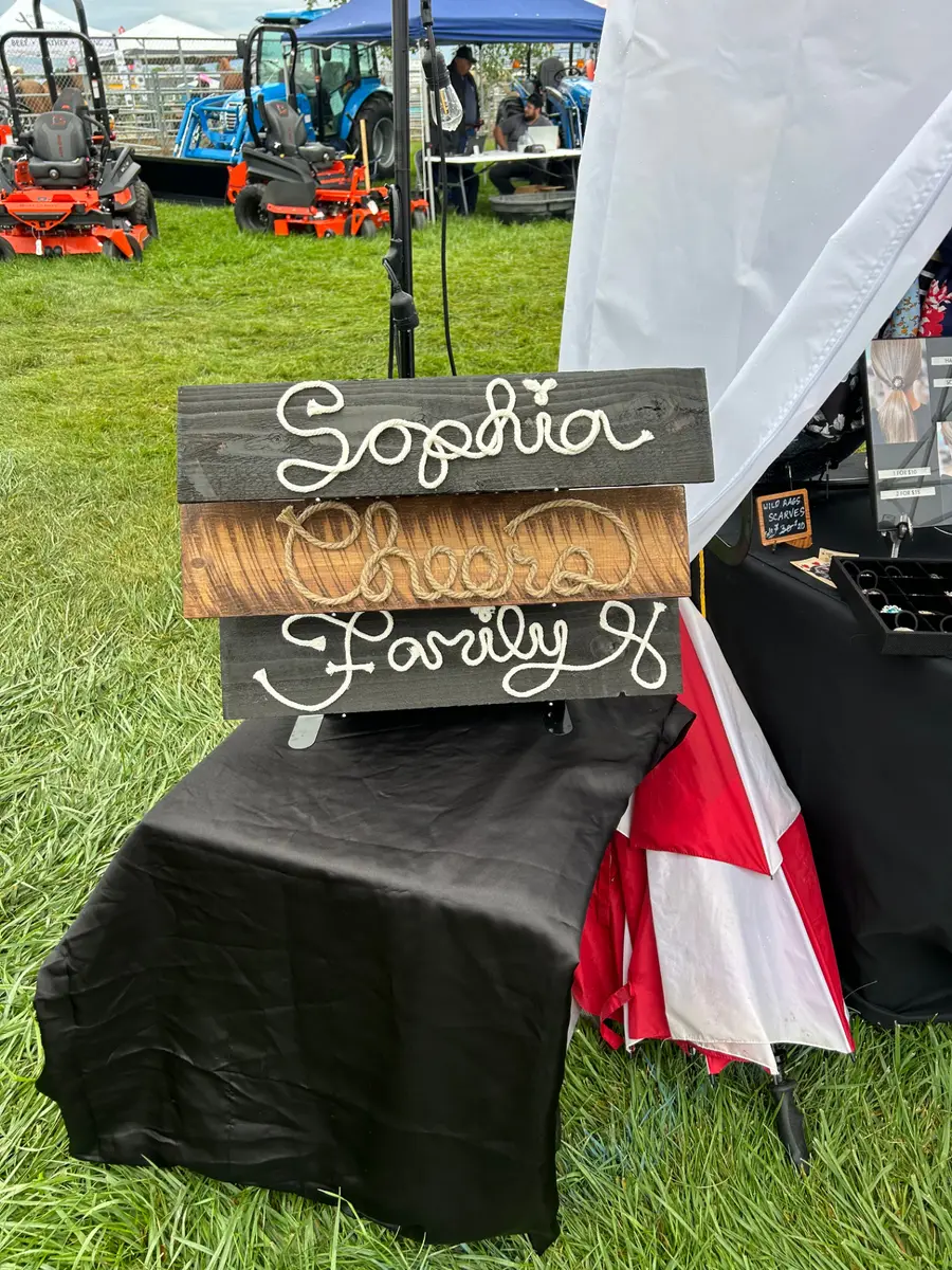 Custom rope-lettered wooden signs spelling Sophia, Cheers, and Family